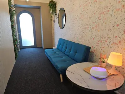 a living room with a blue couch and a table at Le Melur in George Town