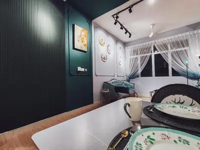 a dining room with a table with plates on it at Moon Classic Falim by Irainbow in Ipoh