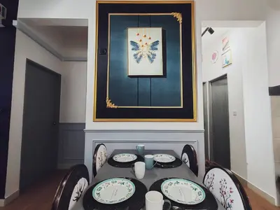 a dining room with a table with plates on it at Moon Classic Falim by Irainbow in Ipoh