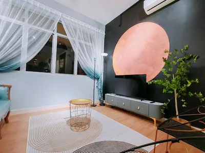 a living room with a table and a plant at Moon Classic Falim by Irainbow in Ipoh
