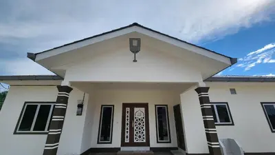 a white house with a front door at Villa Fatima in Sitiawan