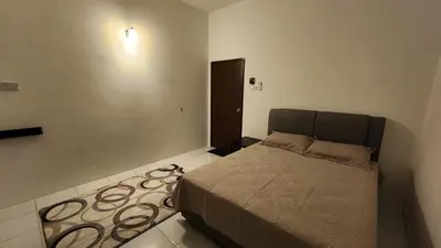 a bedroom with a bed and a rug at Villa Fatima in Sitiawan