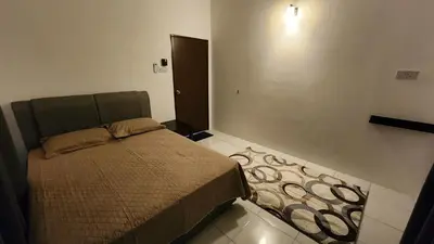 a small bedroom with a bed in a room at Villa Fatima in Sitiawan