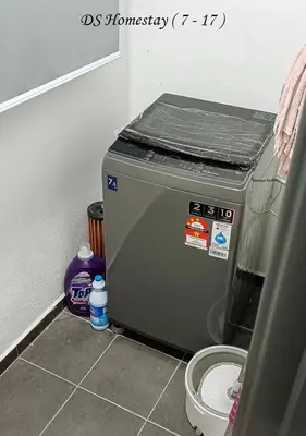 a washing machine sitting on the floor in a bathroom at Metropol Serviced Apartment Nice Pool View 3 BR in Bukit Mertajam