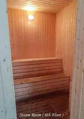 a wooden sauna with a bench in a room at Metropol Serviced Apartment Nice Pool View 3 BR in Bukit Mertajam