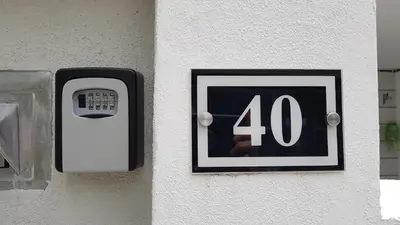 a number sign on the side of a wall at Cosy 2-Storey Holiday Home Vines 2 @Pasar Malam -1 in Brinchang