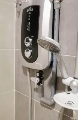 a hair dryer is attached to a wall in a bathroom at Cosy 2-Storey Holiday Home Vines 2 @Pasar Malam -1 in Brinchang