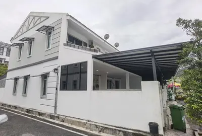 a white house with a white wall at Cosy 2-Storey Holiday Home Vines 2 @Pasar Malam -1 in Brinchang