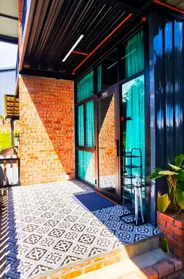 an entrance to a brick building with a glass door at Campod Resort @ Cameron Highlands in Cameron Highlands