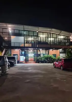 a building with cars parked in a parking lot at night at Campod Resort @ Cameron Highlands in Cameron Highlands