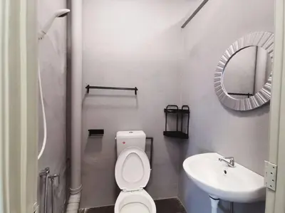 a bathroom with a toilet and a sink and a mirror at Ipoh town centre glamping home 13pax in Ipoh