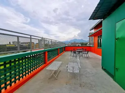 a balcony with chairs and tables on a building at Ipoh town centre glamping home 13pax in Ipoh