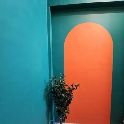 a building with a door with a plant next to it at ipoh town centre - nordic 7pax in Ipoh