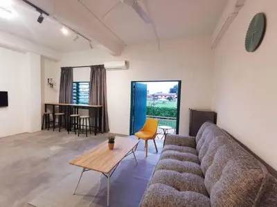 a living room with a couch and a table at ipoh town centre - nordic 7pax in Ipoh