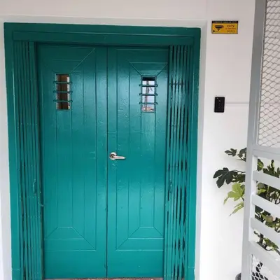 a green door with a window in a building at ipoh town centre - nordic 7pax in Ipoh