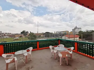 a patio with tables and chairs on a balcony at Ipoh town centre -rustic home 4pax (studio 5) in Ipoh