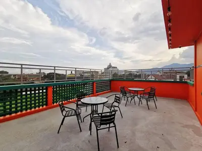 a patio with tables and chairs on a balcony at Ipoh town centre -rustic home 4pax (studio 5) in Ipoh