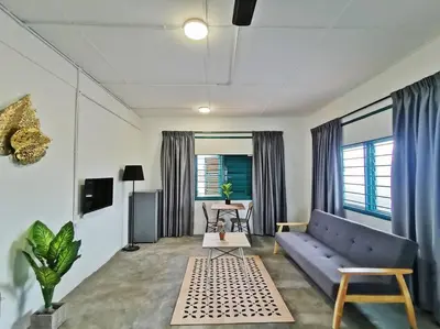 a living room with a blue couch and a table at Ipoh town centre-retro 4pax (studio 6) in Ipoh