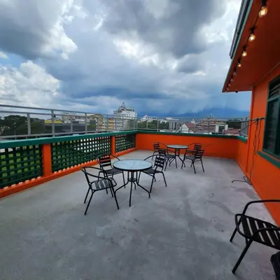 a patio with tables and chairs on a balcony at Ipoh town centre-retro 4pax (studio 6) in Ipoh