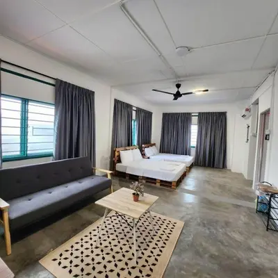 a living room with a bed and a couch at Ipoh town centre-retro 4pax (studio 6) in Ipoh