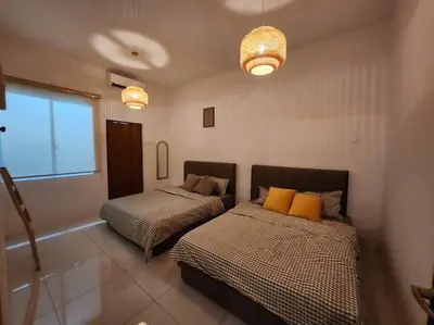 a bedroom with two beds and a window at Botani Ipoh wabi sabi inshome 18 in Ipoh