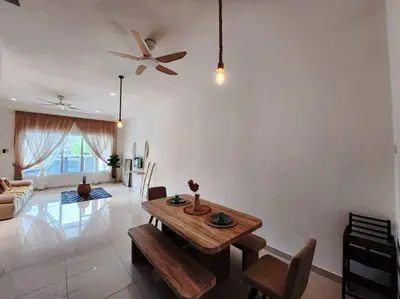 a living room with a table and a ceiling fan at Botani Ipoh wabi sabi inshome 18 in Ipoh