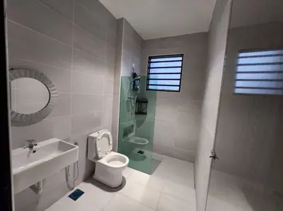 a bathroom with a sink toilet and a mirror at Botani Ipoh wabi sabi inshome 18 in Ipoh