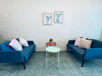 a living room with two blue couches and a table at myROOM @ Mandalay Georgetown, Off Jln Burma, Gurney Drive in George Town
