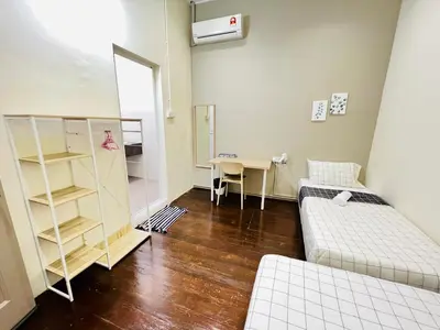 a room with two beds and a desk and a table at myROOM @ Mandalay Georgetown, Off Jln Burma, Gurney Drive in George Town
