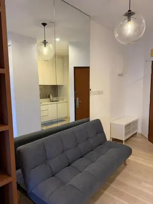 a blue couch in a living room with a mirror at 118 Apartment Tanjung Tokong by Yen's Sojourn in George Town
