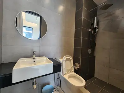 a bathroom with a sink and a toilet and a mirror at Executive Urban Suites - George Town @ Penang in Jelutong