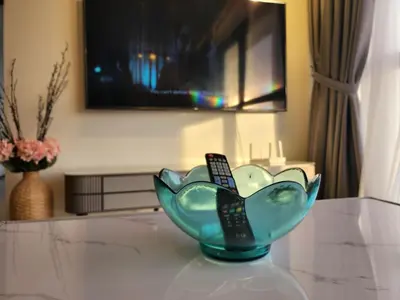 a blue glass bowl on a table with a remote control at Executive Urban Suites - George Town @ Penang in Jelutong