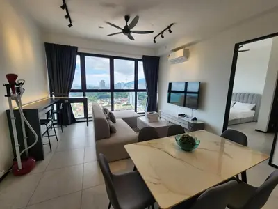 a living room with a table and a couch at Executive Urban Suites - George Town @ Penang in Jelutong
