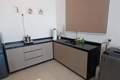 a small kitchen with a black counter top at Stylish Urban Suite Penang - with infinite pool in Jelutong