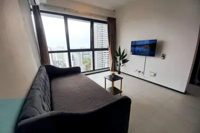 a living room with a couch and a large window at Stylish Urban Suite Penang - with infinite pool in Jelutong
