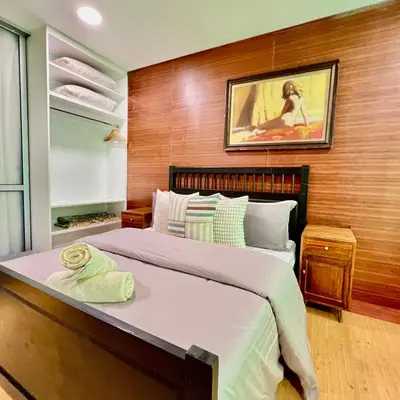 a bedroom with a large bed with a wooden wall at Pertak Malai @ Kuala Kubu Bharu in Kuala Kubu Baharu