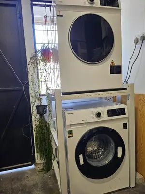 a washing machine with a microwave on top of it at le melur guest house in George Town
