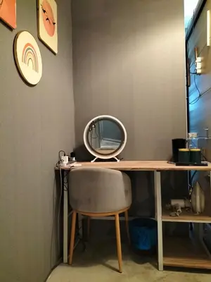 a desk with a mirror and a chair at le melur guest house in George Town