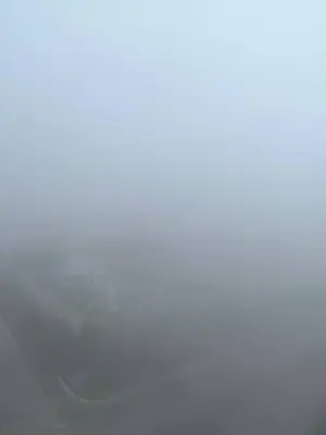 a car is driving through a foggy field at Alliv NSF Studio & 1 Bedroom Apartment Stay in Brinchang