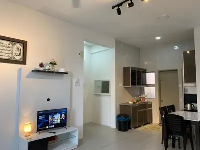 a living room with a television and a dining room at Alliv NSF Studio & 1 Bedroom Apartment Stay in Brinchang