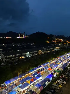 a long line of tents in a parking lot at night at Alliv NSF Studio & 1 Bedroom Apartment Stay in Brinchang
