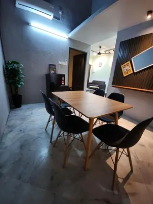 a wooden table and chairs in a room at Sun Star Home by Ipoh Maju Stay in Ipoh