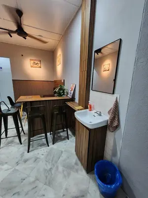 a bathroom with a sink and a counter with a mirror at Sun Star Home by Ipoh Maju Stay in Ipoh