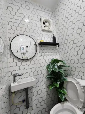 a bathroom with a toilet and a sink and a mirror at Sun Star Home by Ipoh Maju Stay in Ipoh