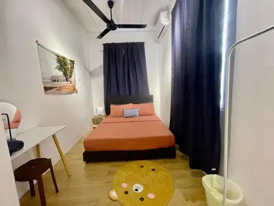 a bedroom with a bed and a table in a room at Home11A#4pax#Netflix#AlmaBukitMertajam in Bukit Mertajam
