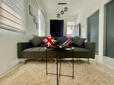 a couch with patriotic pillows on a table in a living room at Home11A#4pax#Netflix#AlmaBukitMertajam in Bukit Mertajam