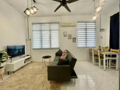 a living room with a couch and a television at Home11A#4pax#Netflix#AlmaBukitMertajam in Bukit Mertajam