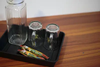 a black tray with a glass vase on a table at Brown Mansion CoLiving in George Town