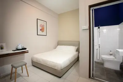 a bedroom with a bed and a sink and a toilet at Brown Mansion CoLiving in George Town