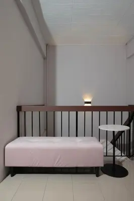 a bed and a table in a room at Brown Mansion CoLiving in George Town